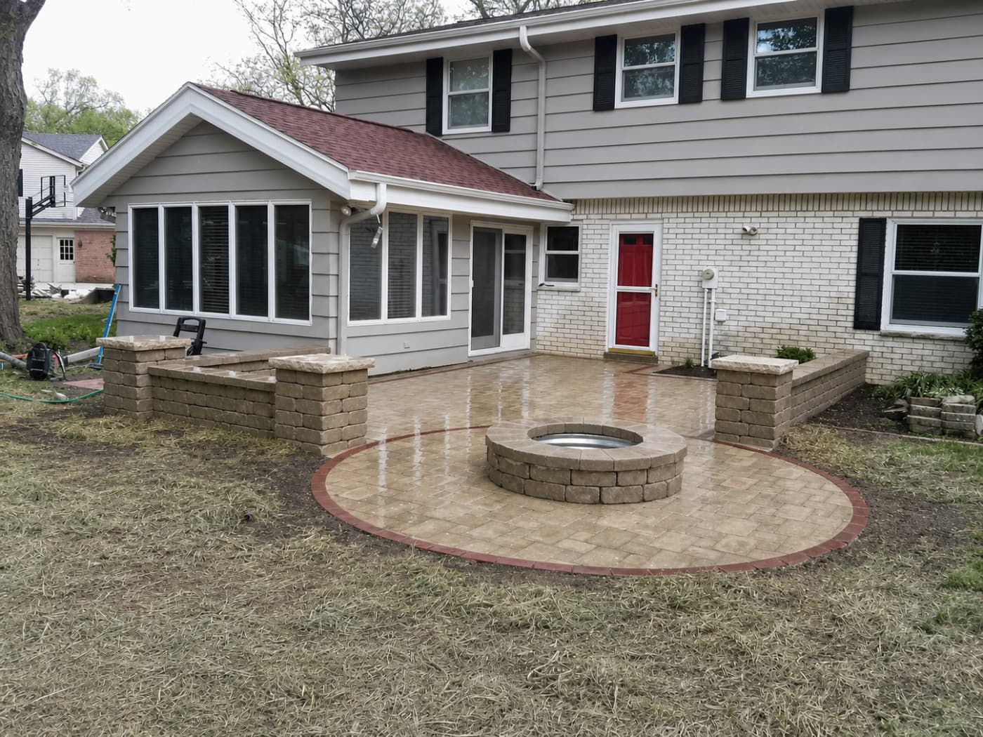 Stamped concrete patio and fire pit off the back of a house