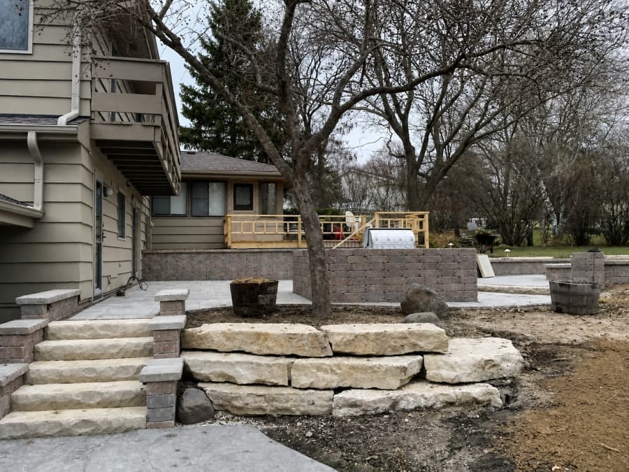 Limestone outcropping steps and a block retaining wall going in